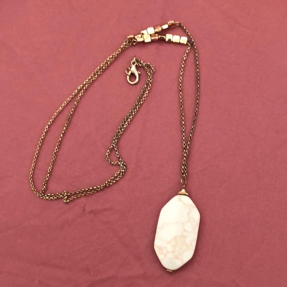 Gold necklace with white stone